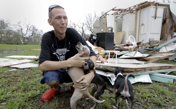 Sam Speights tries to hold back tears while surveying the damage to his home after Hurricane Harvey struck Rockport, Texas, last September. He had to move to other shelter.