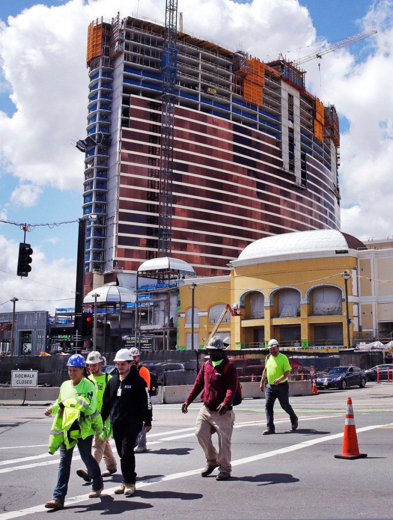 Construction continues on a $2.5 billion casino in Everett, Mass., but it will no longer be named after Wynn Resorts founder Steve Wynn, who faces multiple allegations of sexual misconduct.