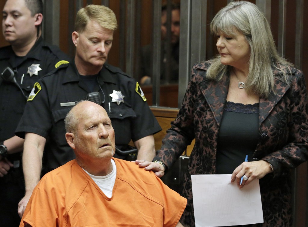 Joseph James DeAngelo, 72, who authorities suspect is the so-called Golden State Killer responsible for at least a dozen murders and 50 rapes in the 1970s and 80s,  is accompanied by Sacramento County Public Defender Diane Howard, right, as he makes his first appearance, Friday, April 27, 2018, in Sacramento County Superior Court in Sacramento, Calif. (AP Photo