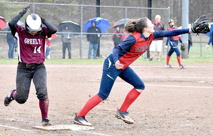 Kelsey Currier of Greely makes it to first as Gray-New Gloucester first baseman Jordan Grant reaches to catch a late throw Friday during Greely's come-from-behind 4-3 victory. Currier reached base four times.