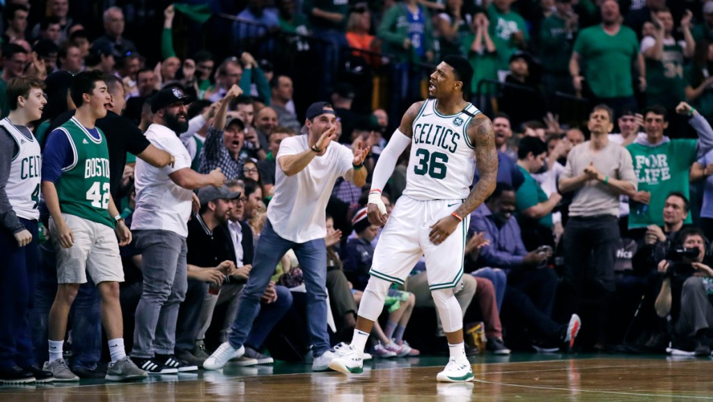 Celtics guard Marcus Smart celebrates a basket with fans during Game 7 of Boston's first-round playoff series Saturday night against the Milwaukee Bucks. The Celtics advanced with a 112-96 win.