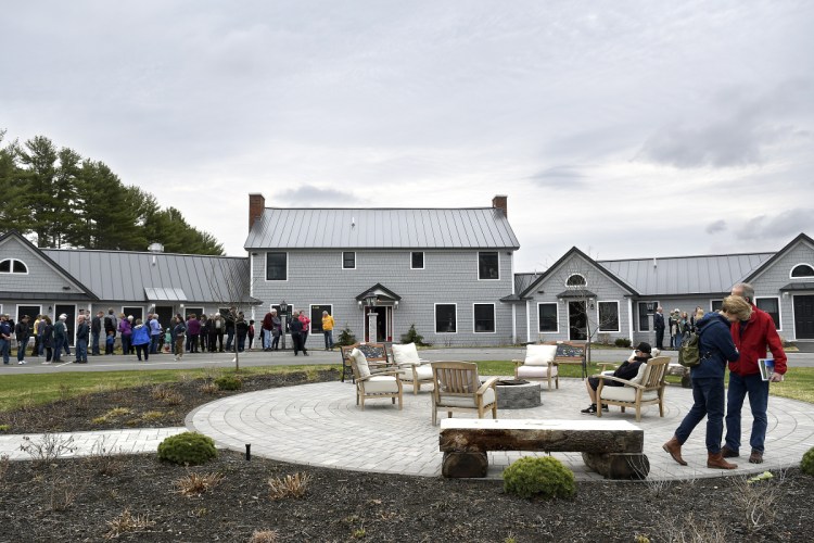 Visitors check out the grounds at the Mills foundation retreat – the former Elizabeth Arden estate perched on a hill overlooking Long Pond in northwestern Kennebec County.