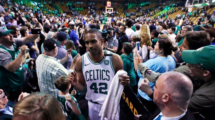 Boston forward Al Horford wades through a crowd of support at TD Garden after the Celtics defeated the Milwaukee Bucks in Game 7 of their first-round playoff series on Saturday night. (AP Photo/Charles Krupa)