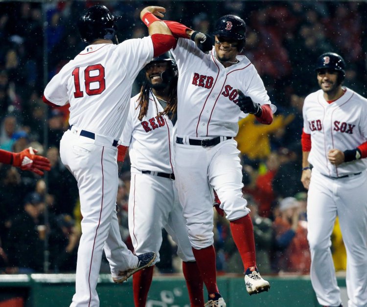 Boston's Xander Bogaerts, center, celebrates after hitting a grand slam in the third inning of a 10-6 win on Monday in Boston.