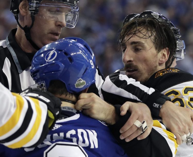 Bruins left wing Brad Marchand, right, and Lightning center Tyler Johnson scrap during the first period of Game 2 of their second-round series Monday in Tampa, Fla. Tampa Bay won 4-2 to even the series at 1-1.
