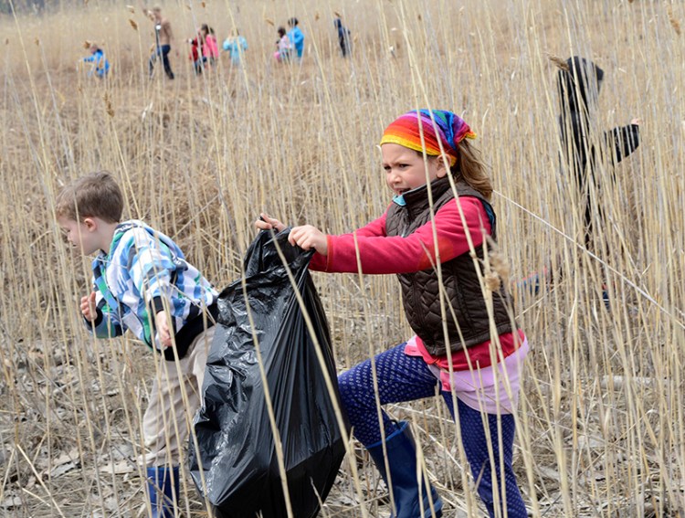 Maine Audubon's April vacation camp in Falmouth to celebrate Earth Day that includes picking up trash along the marsh. Declan Rowles, 6 yrs. and Talia Olins, 7yrs. take part in 2014.