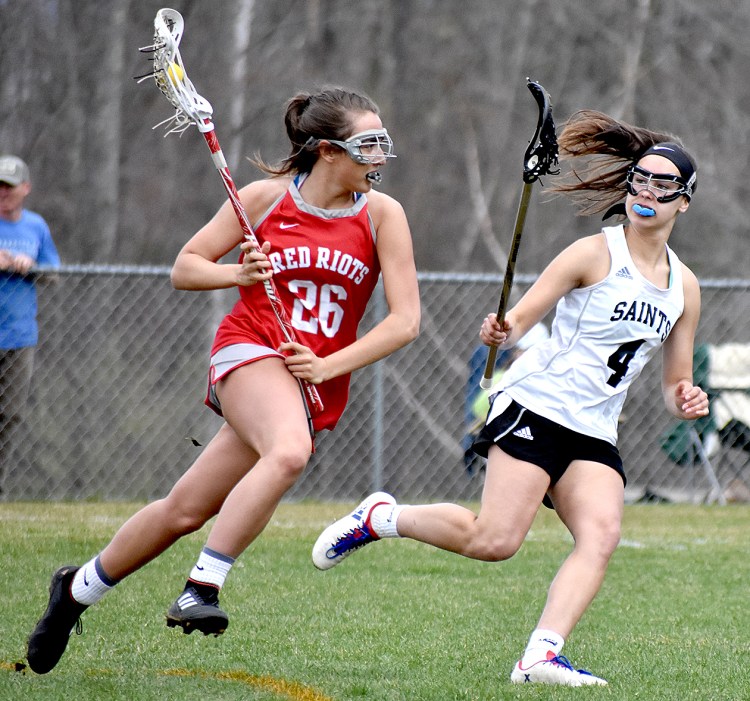 South Portland's Amelia Pappalardo goes on the attack against St. Dominic Academy's Rileigh Stebbins during their game in Auburn on Saturday. St. Dom's won, 20-6.