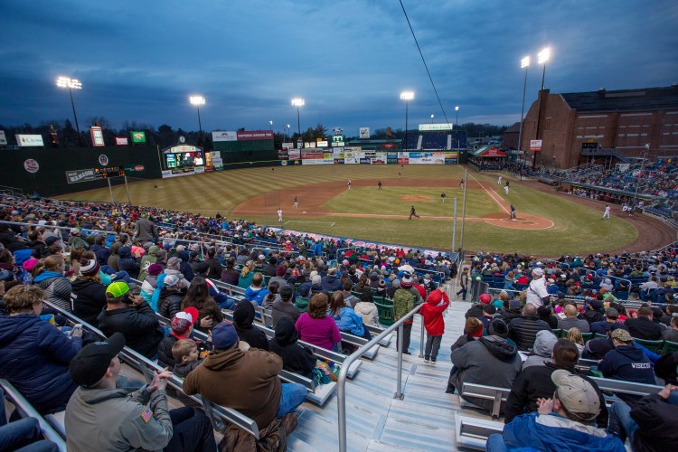 Fans cheer as the Sea Dogs get a hit on Friday night in their home opener at Hadlock Field.