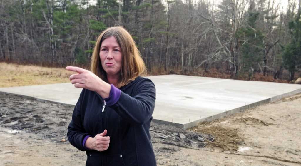 Standing in front of a foundation that was poured recently to enable construction of a barn for her cows at her Richmond home, Daria Goggins talks at Nov. 21, 2015, about finding her pair of Holsteins shot and killed a day earlier. Goggins said Friday she is increasing a reward for information on the case from $2,500 to $5,000.