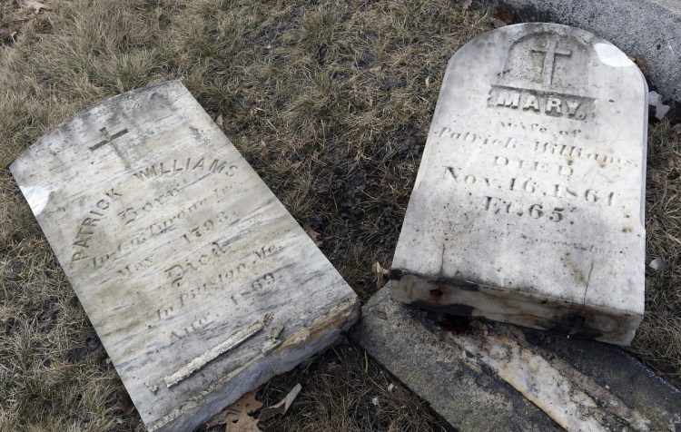 The damaged headstones of Irish immigrants are seen last month at St. Denis Cemetery in Whitefield after a car crashed into the cemetery.