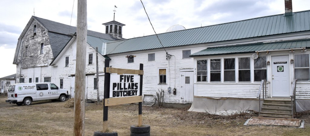 A sign outside the Five Pillars Butchery farm on the Detroit Road in Troy, seen Wednesday, has been repaired. Someone shot and damaged the sign Sunday, but Hussam Alrawi fixed it after police investigated, saying he wants to send a message that he and his family are in Troy to stay.