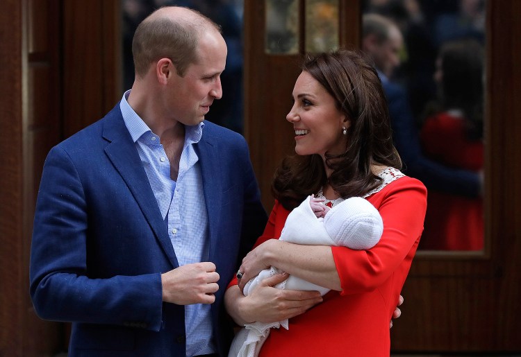 Britain's Prince William and Kate, Duchess of Cambridge, pose for a photo with their newborn son as they leave the Lindo wing at St Mary's Hospital in London on Monday. The Duchess of Cambridge gave birth Monday to a healthy baby boy – a third child for Kate and Prince William and fifth in line to the British throne. 