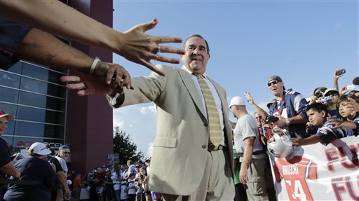 Former New England Patriots broadcaster Gil Santos is congratulated by fans as he walks the red carpet in Foxborough, Mass., on July 29, 2013. Santos and former linebacker Tedy Bruschi were inducted into the Patriots 2013 Hall of Fame. 