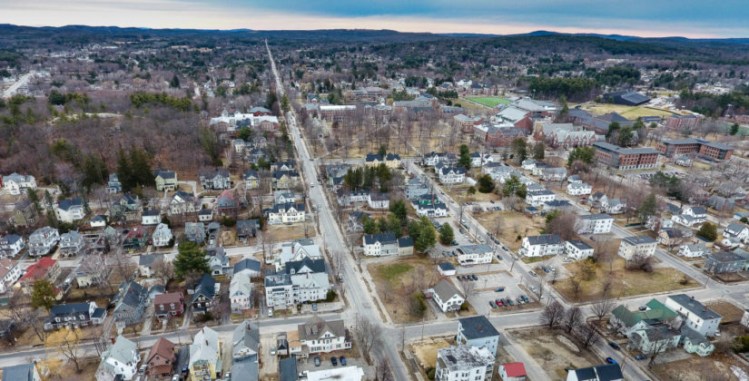 College Street runs down the center of the frame dividing much of the Bates College campus and neighborhoods mixed with families, elderly and young college students.  