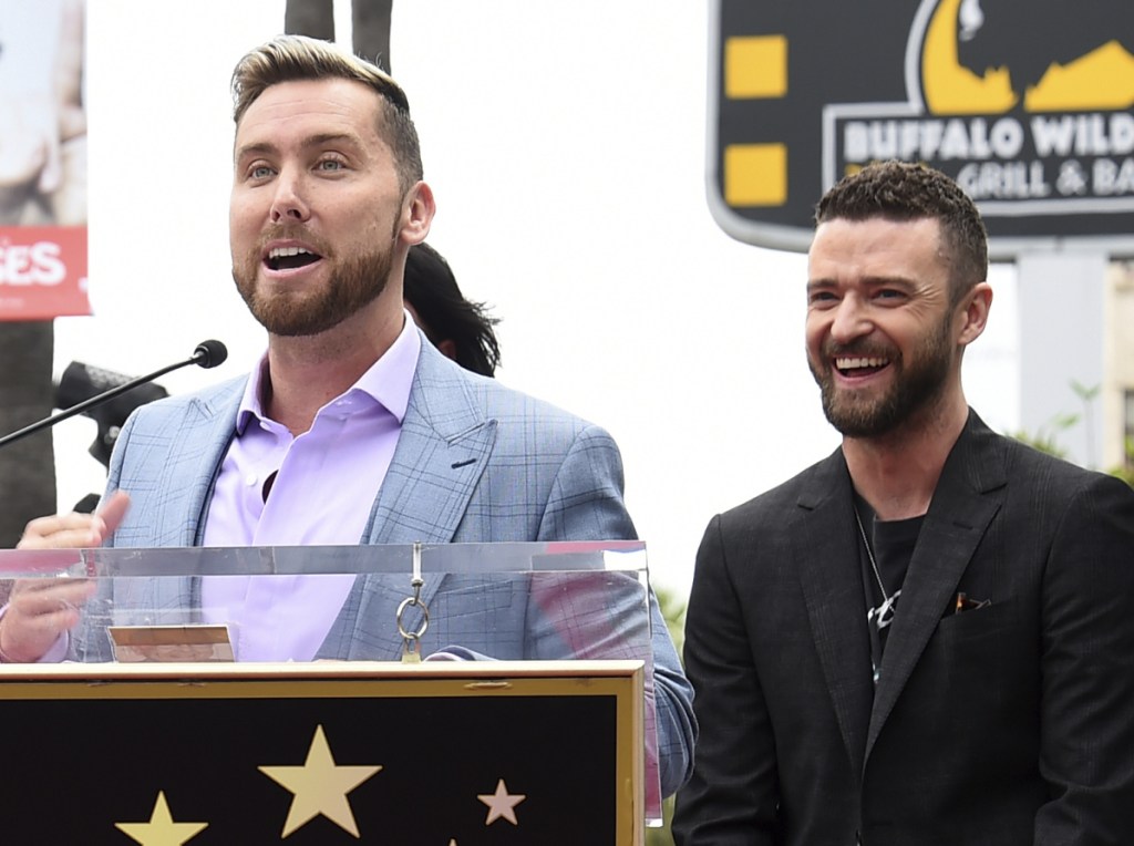 Lance Bass speaks at a ceremony honoring 'NSync with a star on the Hollywood Walk of Fame on Monday. At right is Justin Timberlake.