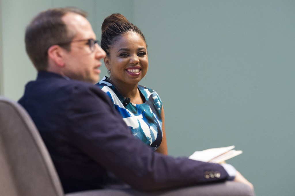 Jemele Hill, right, smiles during an introduction by Justin McCann before her "Freedom to Speak: A Conversation with Jemele Hill on Athletics and Activism" event Tuesday night at Ostrove Auditorium at Colby College. (Staff photo by Michael G. Seamans)