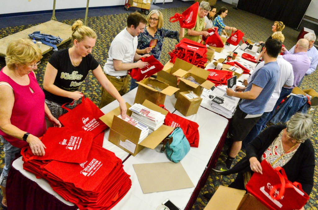 Volunteers stuff brochures into bags Thursday at the Augusta Civic Center in preparation for the last Republican state convention to be held during Gov. Paul LePage's tenure.