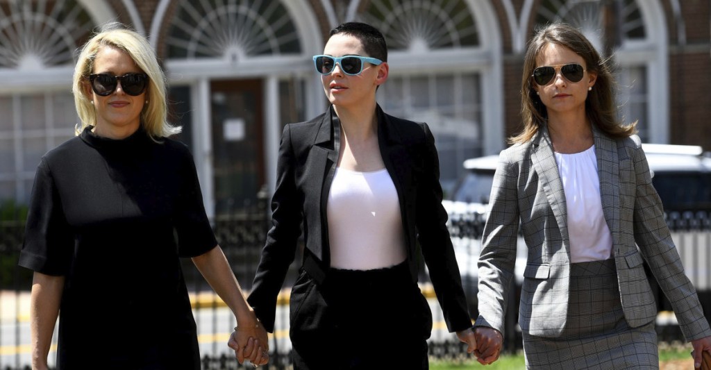 Actress Rose McGowan, center, and her attorney Jessica Carmichael, right, arrive for a preliminary hearing on her drug possession charge Thursday in Leesburg, Va.