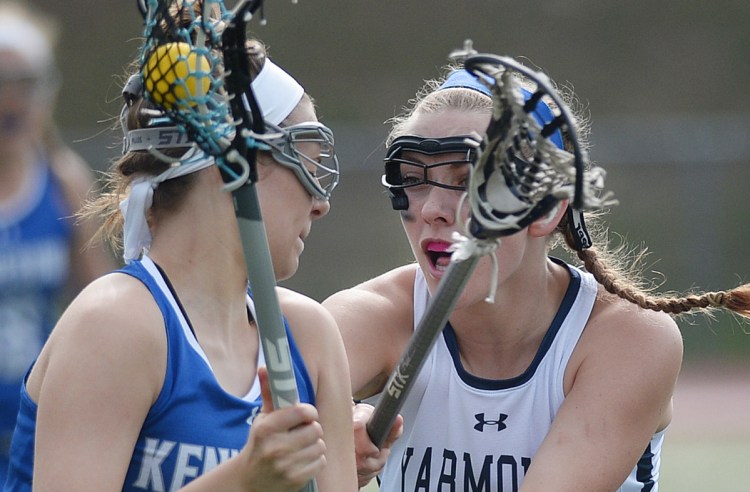 Isabel Brennan of Yarmouth, right, plays tight defense on Liz Kiezulas of Kennebunk during their girls' lacrosse game Thursday. Kennebunk, which beat the Clippers in the Class B state final last year before moving to Class A, came away with a 12-5 victory.