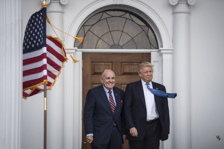 Then President-elect Donald Trump greets Rudy Giuliani at the clubhouse at Trump National Golf Club Bedminster in Bedminster Township, N.J. on Nov. 20, 2016.