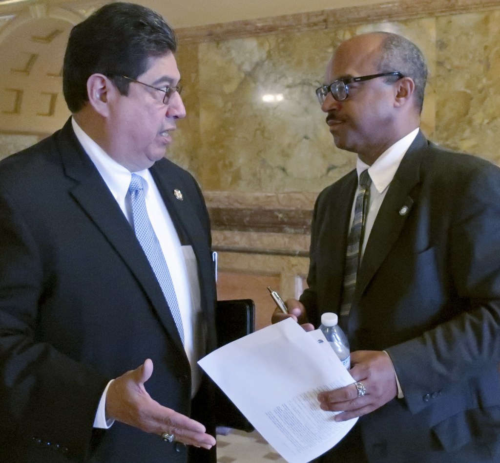 Kansas state Rep. Louis Ruiz, left, and Sen. David Haley, both D-Kansas City, confer during a break in negotiations on adoption legislation Thursday.