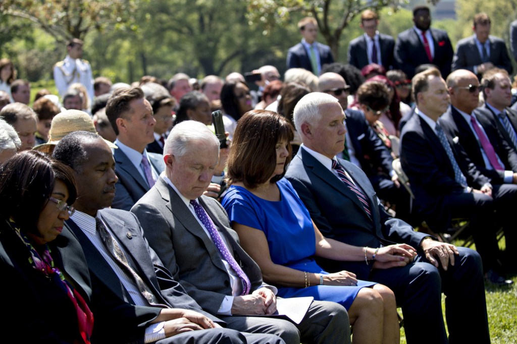 From right: Vice President Mike Pence, second lady Karen Pence, Attorney General Jeff Sessions, HUD chief Ben Carson, and Carson's wife, Candy, listen to a prayer during a National Day of Prayer ceremony in the Rose Garden of the White House on Thursday. MUST CREDIT: Bloomberg photo by Andrew Harrer