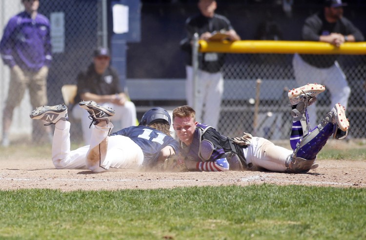 Westbrook's Maxim Dobkowski is safe at home after colliding with Deering catcher Jack Lynch during an SMAA baseball game Saturday in Westbrook. Deering won, 16-8.
