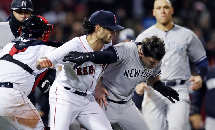 New York Yankees' Tyler Austin, right, scuffles with Boston Red Sox relief pitcher Joe Kelly, after being hit by a pitch during a game at Fenway Park on April 11. (AP Photo/Charles Krupa)