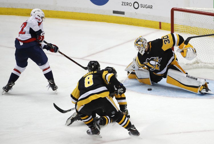 Washington Capitals' Evgeny Kuznetsov (92) gets the game-winning goal between the pads of Pittsburgh Penguins goaltender Matt Murray (30) during the overtime period in Game 6 of an NHL second-round hockey playoff series in Pittsburgh, Monday, May 7, 2018. The Capitals won 2-1 to win the series, four games to two. (AP Photo/Gene J. Puskar)