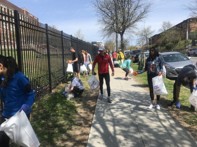 Running coach Jeff Horowitz, in red, and ploggers pick up trash in Washington, D.C.