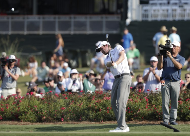 Webb Simpson hits from the drop zone after hitting a ball into the water on the 17th hole Friday during the second round of The Players Championship. Didn't matter. He tied the course record with a 63 and holds a five-shot lead.
