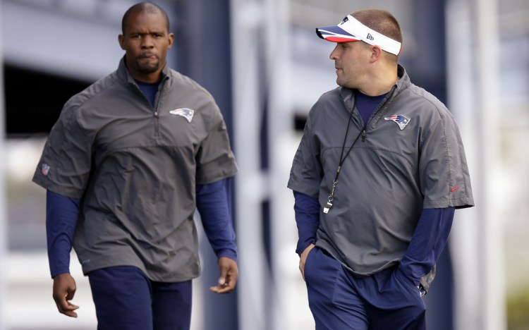 Josh McDaniels, right, turned down the Indianapolis Colts to remain with the Patriots, and Brian Flores, left, will call New England's defensive plays next season.