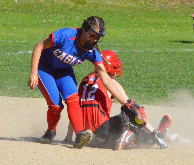 Mt. Ararat shortstop Zoe Stilphen is late with the tag as Amy Kunzinger of Camden Hills slides in safely at second base. Mt. Ararat won in eighth innings, 13-12.
