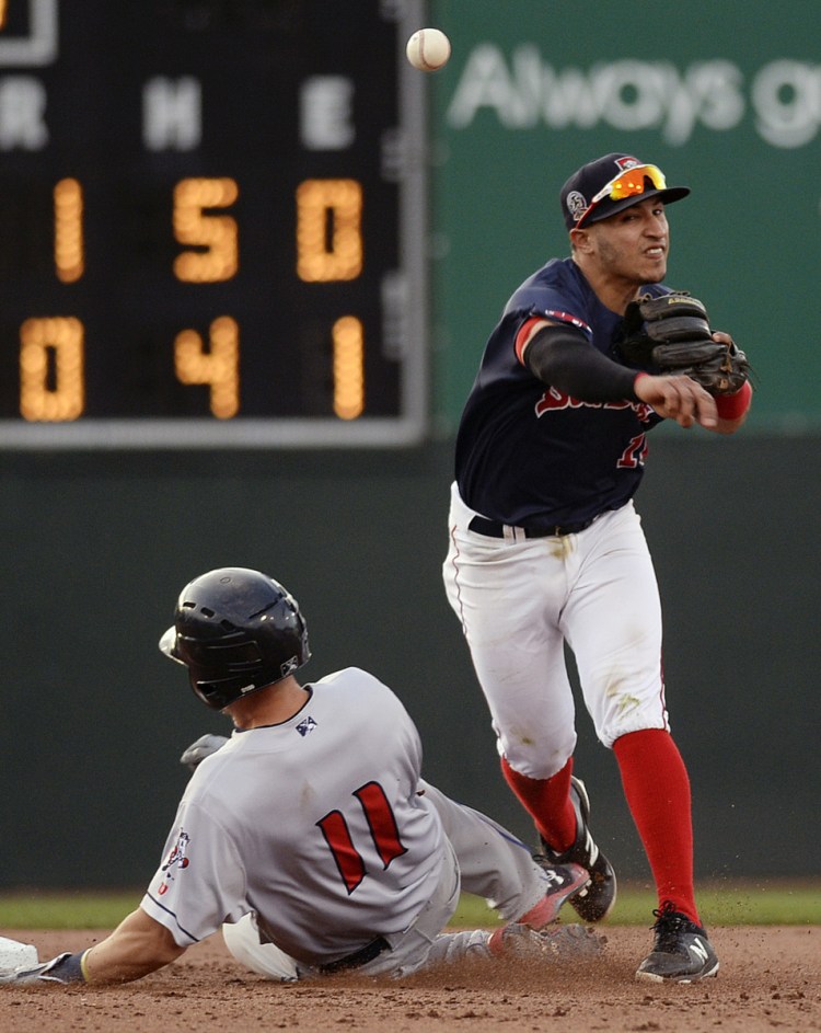 Jeremy Rivera turns the double play – one of four by the Sea Dogs in the game – as Binghamton's Patrick Mazeika slides into second base during Portland's 5-1 loss Friday night at Hadlock Field.
