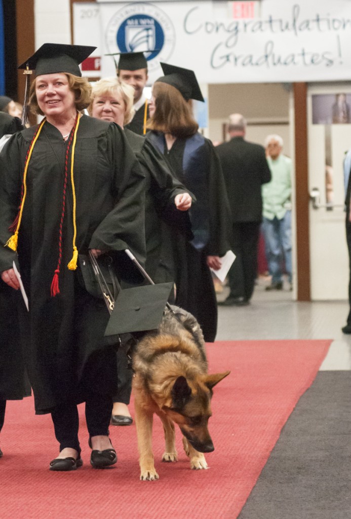 AUGUSTA, ME - MAY 12: Lynn Merrill and her guide dog Libby walk into the University of Maine at Augusta graduation on Saturday May 12, 2018 in the Augusta Civic Center. Merrill was the student speaker during the ceremony. (Staff photo by Joe Phelan/Staff Photographer)