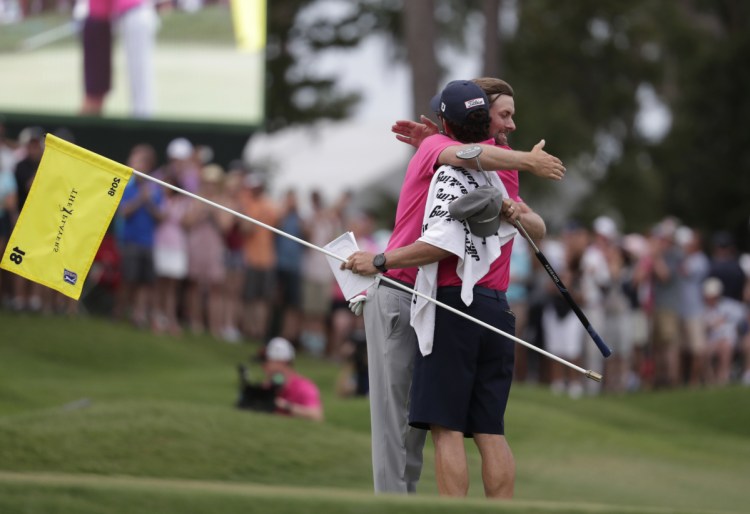 Webb Simpson and his caddie Paul Tesori congratulate each other after winning The Players Championship Sunday in Ponte Vedra Beach, Fla.