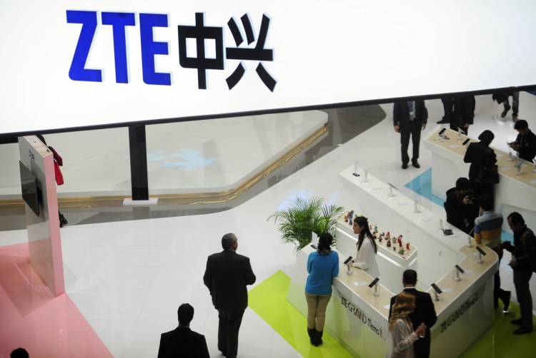 People gather at the ZTE booth at the Mobile World Congress, the world's largest mobile phone trade show, in Barcelona, Spain, in 2014. ZTE halted operations after U.S. authorities cut off its access to American suppliers.