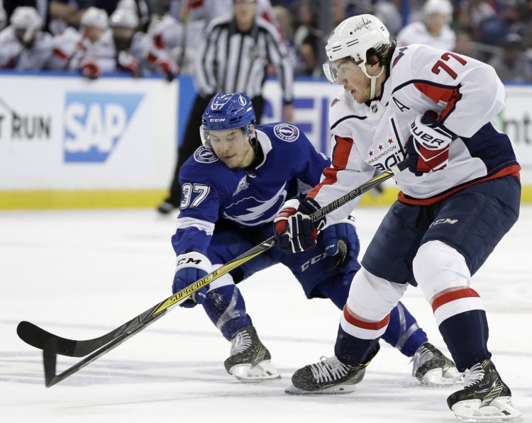 Tampa Bay center Yanni Gourde knocks the puck away from T.J. Oshie of the Capitals during Game 2 of the Eastern Conference finals Sunday night. Washington won, 6-2.