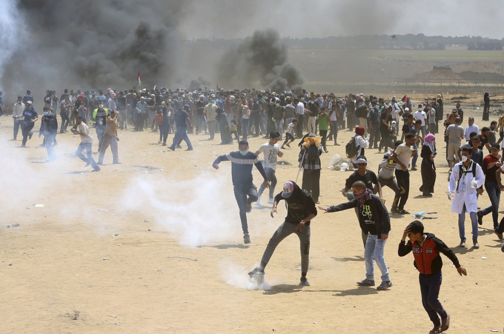 Palestinian protesters burn tires Monday near the Israeli border fence, east of Khan Younis, in the Gaza Strip.