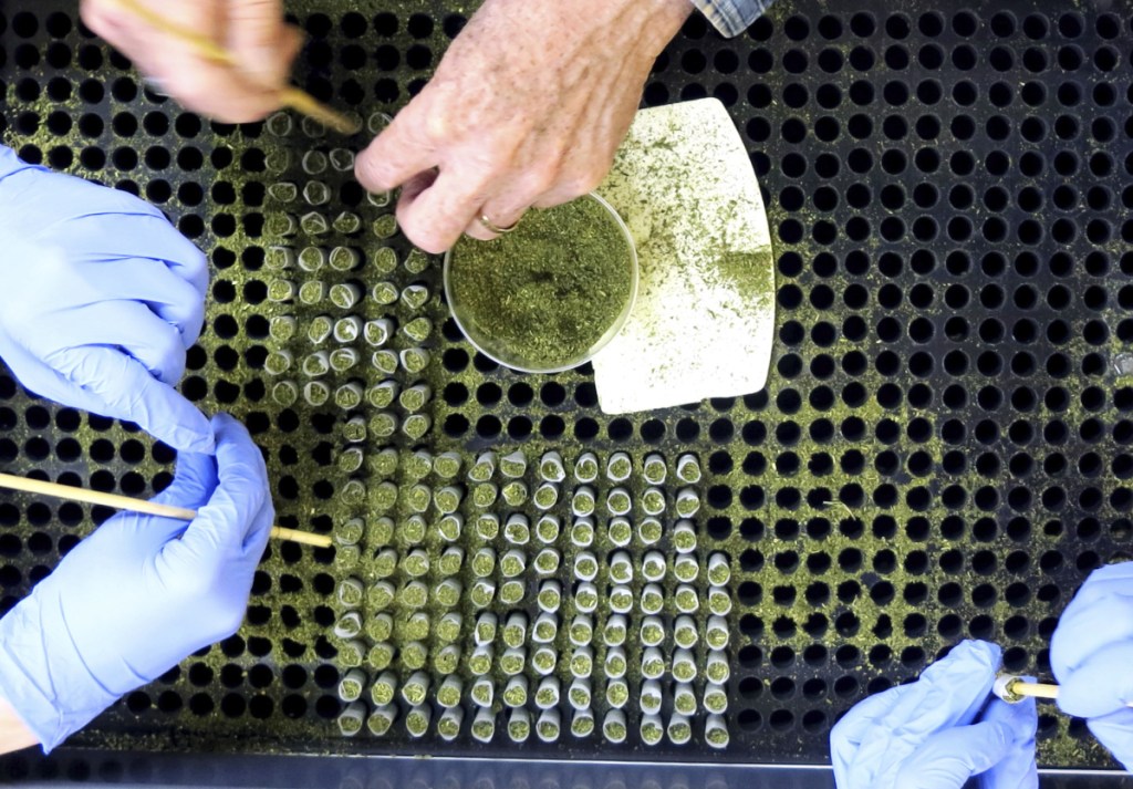 Workers assemble pre-rolled cigarettes of hemp flower containing cannabidiol, or CBD, at a hemp handling facility in Salem, Ore. Applications for state licenses to grow hemp have increased more than 20-fold since 2015.