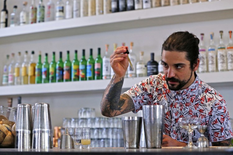 Beverage director Maxwell Reis adds a few drops of cannabidiol CBD extract to a mixed drink at the Gracias Madre restaurant in West Hollywood, Calif. The hemp-derived CBD extract is popping up in everything, including cosmetics, chocolate bars, bottled water and pet treats.