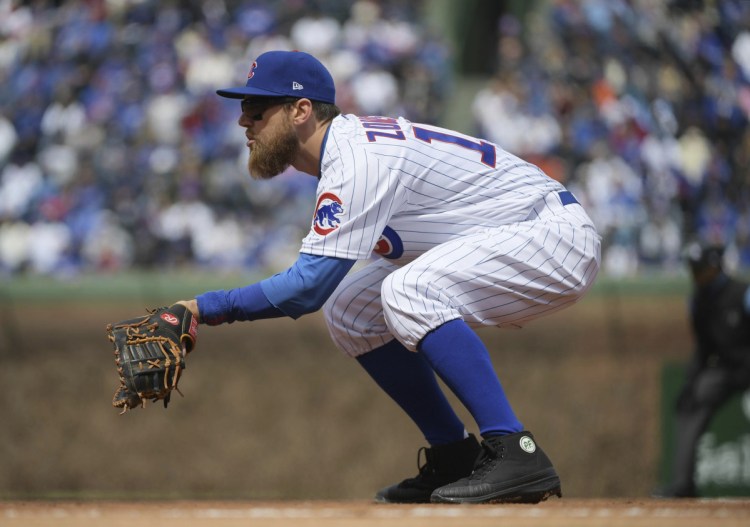FILE - In this April 10, 2018, file photo, Chicago Cubs first baseman Ben Zobrist plays in place of the injured Anthony Rizzo during the team's baseball game against the Pittsburgh Pirates at Wrigley Field in Chicago. Major League Baseball has warned Zobrist against wearing black cleats. Zobrist posted a letter from the league office on Instagram saying the cleats he wore May 2 against Colorado violated the collective bargaining agreement. MLB says they must be at least 51 percent blue--the Cubs' color--and warned he could be fined and disciplined if he doesn't comply. Zobrist says he has worn black cleats for day games at Wrigley Field the past two years to honor the game's past. (John Starks/Daily Herald via AP)