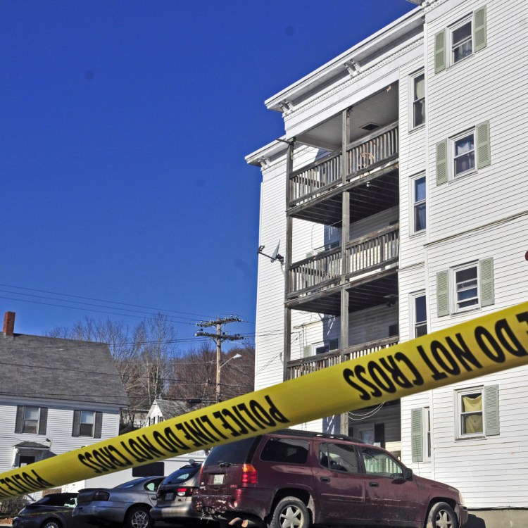 Police tape surrounds the parking lot at 75 Washington St. Nov. 24, 2015, in Augusta. The body of Joseph Marceau was found there in a fourth floor apartment.