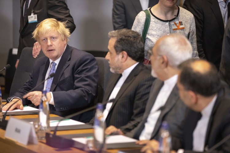 British Foreign Secretary Boris Johnson, left, talks during a meeting of the foreign ministers from Britain, France and Germany with the Iran Foreign Minister Javad Zarif and EU foreign policy chief Federica Mogherini in Brussels on Tuesday. Major European powers sought Tuesday to keep Iran committed to a deal to prevent it from building a nuclear bomb despite deep misgivings about Tehran's Middle East politics and President Trump's vehement opposition.