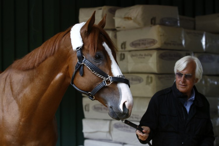 Kentucky Derby winner Justify walks in a barn with trainer Bob Baffert on Wednesday after Justify's arrival at Pimlico Race Course in Baltimore.