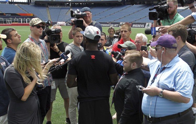Members of the media surround Duke Dawson, the second round pick of the New England Patriots, on Tuesday at Gillette Stadium in Foxborough, Mass. He signed with the team on Wednesday.