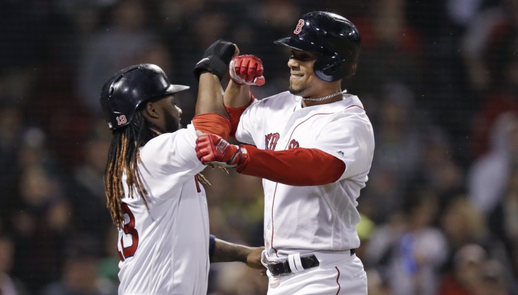 Boston's Xander Bogaerts, right, is congratulated by Hanley Ramirez after hitting a three-run home run in the sixth inning Wednesday night at Fenway Park.