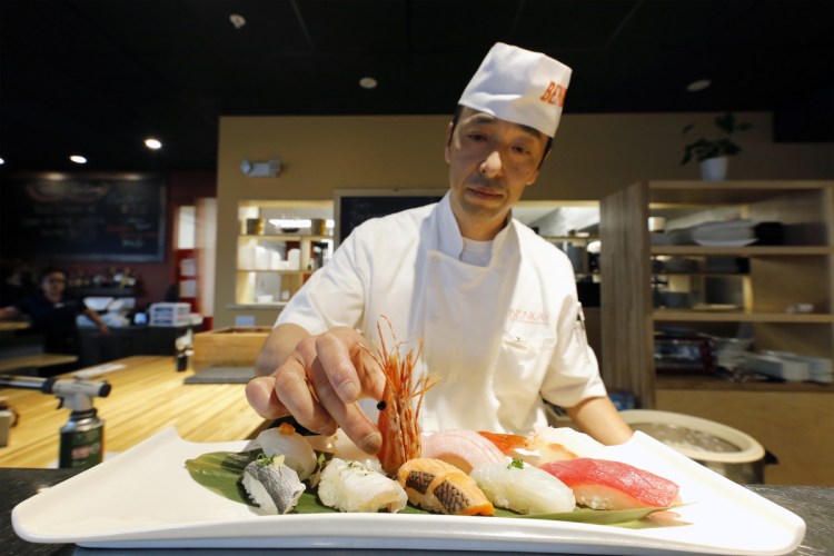 Benkay sushi chef Hiro Ishii adds a shrimp head as the centerpiece of Omakase – a sushi platter whose name roughly translates to "chef's choice."