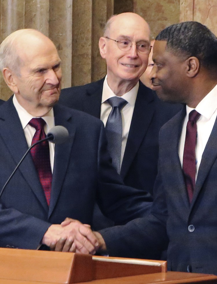 Mormon church President Russell M. Nelson shakes hands with Derrick Johnson, president of the NAACP, during a news conference Thursday in Salt Lake City.