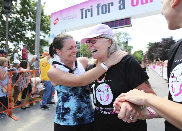 Julie Degenhardt celebrates with her mother, cancer survivor Joanne Longacre, after last year's Tri for a Cure. The event is one of three in Maine that sell out in a day.